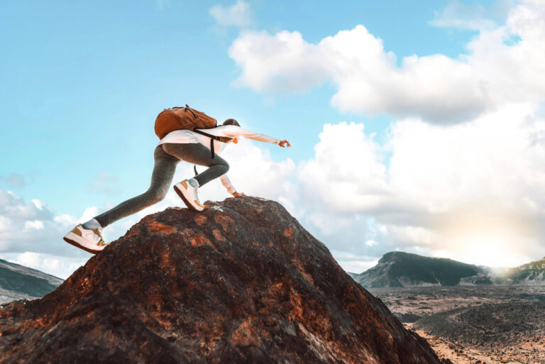 a female hiker on the peak of a mountain